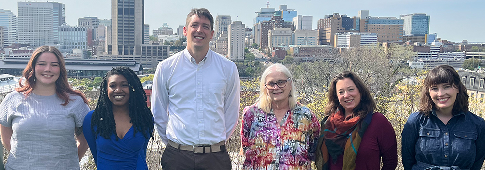 The childsavers staff standing on a hill.