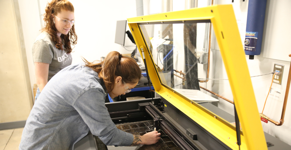 Photo of a student learning 3D printing techniques in the Makerspace.