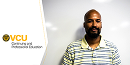 Man standing in front of a whiteboard wearing a striped polo shirt, next to the VCU Continuing and Professional Education logo